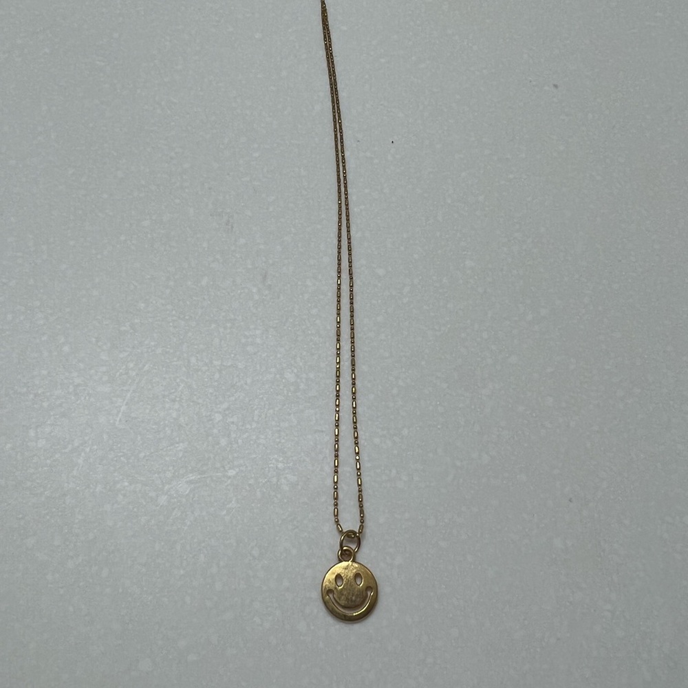 Gold smiley face necklace